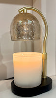 Decorative lamp with a candle inside on a white surface
