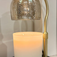 Decorative lamp with a candle inside on a white surface