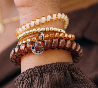 Pack Contents | 5 hair ties: 3 Small and 2 Large
Design | Spiral coils with a strong grip
Wearability | Doubles as a wrist accessory
Durability | Water-resistant for everyday wear
Style | Anything But Basic