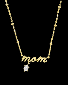 Mom Gold Crystal Short Pendant Necklace
Kendra Scott Mom Necklace
Celebrate the ones who matter most with the Mom Gold Crystal Short Pendant Necklace in White CZ. Featuring a delicate script design and subtle sparkle from white cubic zirconia, this piece is the perfect gift for any mother figure—or a sweet treat for yourself. It’s a timeless reminder of love, gratitude, and everything “Mom” means.

Details:
• Metal: Silver-tone
• Material: White Cubic Zirconia (CZ)
• Dimensions: 19" chain, 0.17"L x 0.71"W p