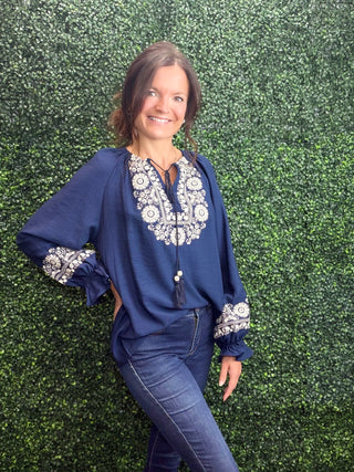 Key Details | Embroidered floral detail on navy ground
Sleeves | Puff sleeve detail for a feminine, fashion-forward silhouette
Fabric | 86% Viscose, 14% Polyamide — soft, lightweight, and breathable
Fit | Relaxed through the body, flattering on all frames
Neckline | Classic, versatile styling