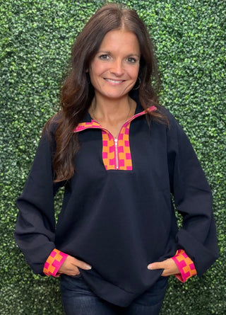 Fabric | 53% Polyester, 42% Cotton, 5% Spandex — soft, breathable, with just enough stretch
Neckline | Quarter zip with checkered trim detail
Cuffs | Matching orange/pink checkered trim at sleeve cuffs
Sleeves | Long sleeve