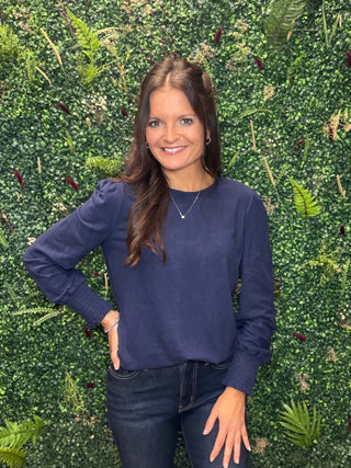 Reach for this elevated navy long sleeve top when you want everyday comfort with a little more polish. Its soft brushed feel, relaxed silhouette, and subtle sleeve detail make it an easy choice for workdays, weekend plans, and everything in between.

Key Details
Fit | Relaxed silhouette
Fabric Feel | Soft brushed rayon, polyester, and spandex blend
Neckline | Classic crew neckline
Sleeves | Long puff sleeves with smocked cuffs
Color | Navy