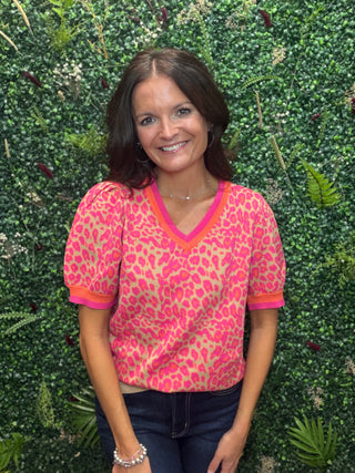 Neckline | V-neck
Sleeve | Short sleeve
Trim Detail | Orange/pink stripe at collar and sleeve hem
Fit | Relaxed, true to size