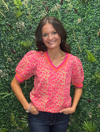 Neckline | V-neck
Sleeve | Short sleeve
Trim Detail | Orange/pink stripe at collar and sleeve hem
Fit | Relaxed, true to size