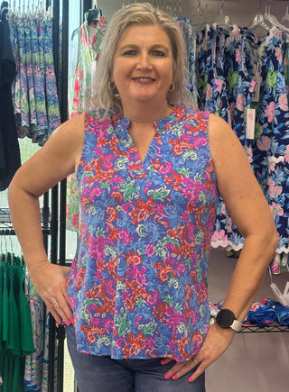 Cool tones, warm-weather ready. This colorful sleeveless top features an A-line bodice with a split neckline and mandarin collar — flowy and relaxed for the kind of effortless style that carries you from morning to evening without missing a beat.