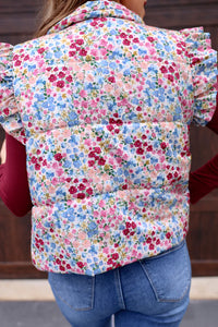 This puffer vest features a gorgeous floral pattern and playful ruffle sleeves, making it the perfect choice for those looking to add a touch of color to their outfit. Don't miss out on this must-have item!