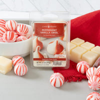Packaged peppermint vanilla swirl wax melts with candy-like appearance on a white surface.