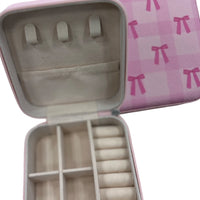Bow Travel Jewelry Organizer
Keep your favorite jewelry organized and tangle-free wherever you go! This stylish bow-adorned organizer has dedicated compartments for earrings, bracelets, rings, and necklaces, making packing a breeze. A secure zip closure ensures everything stays in place, whether you’re traveling near or far. Compact, chic, and functional—your jewelry’s new travel companion.