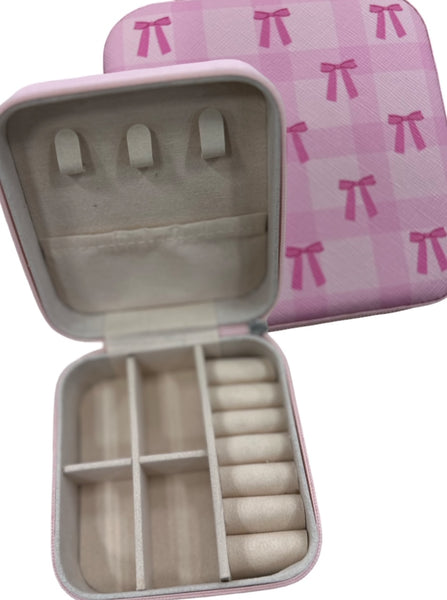 Bow Travel Jewelry Organizer
Keep your favorite jewelry organized and tangle-free wherever you go! This stylish bow-adorned organizer has dedicated compartments for earrings, bracelets, rings, and necklaces, making packing a breeze. A secure zip closure ensures everything stays in place, whether you’re traveling near or far. Compact, chic, and functional—your jewelry’s new travel companion.