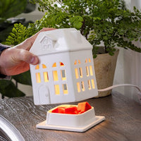 Porcelain House Canopy Fragrance Warmer
Charming porcelain house fragrance warmer with glowing windows. Perfect for farmhouse or rustic decor. Safely warms wax melts for cozy scent and ambiance.