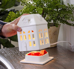 Porcelain House Canopy Fragrance Warmer
Charming porcelain house fragrance warmer with glowing windows. Perfect for farmhouse or rustic decor. Safely warms wax melts for cozy scent and ambiance.