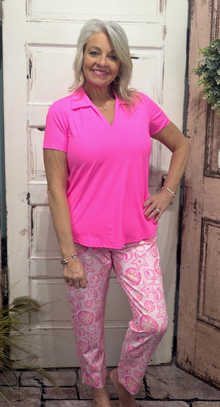 UPF 50 capris are made with breathable, cooling fabric and a flattering 25" inseam

Pattern Features: Hot Pink, Coral, White, Yellow Sea Shell Print

Pants are paired with the Lulu-B Collar Top BHP