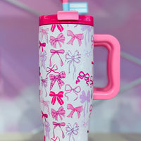 Pink and white tumbler with bow pattern. 40oz tumbler with handle and straw
