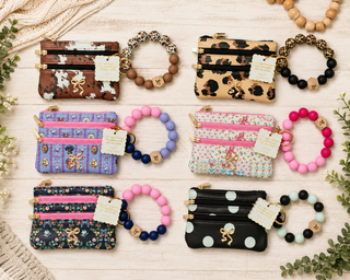 Your keys, cards, and coins — all in one cute little package. The Simply Southern Bead Bangle Wallet keeps your essentials close and your style on point, with a beaded bangle that slips right on your wrist so your hands stay free. Available in a range of fun prints to match your mood.
Prints Available | Cow, Dog Bow, Leopard, Ribbon Floral, Quilted Ribbon, White Dot
