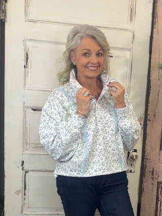 Cinched pullover top with snap collar neckline, dropped shoulders, long sleeves, and adjustable hem, women’s relaxed-fit casual pullover.