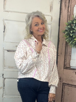 Cinched pullover top with snap collar neckline, dropped shoulders, long sleeves, and adjustable hem, women’s relaxed-fit casual pullover.