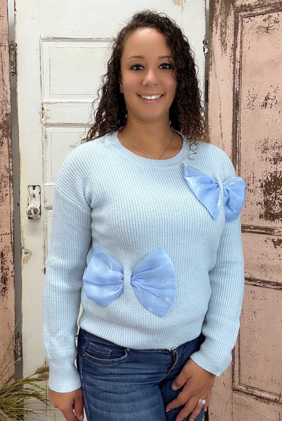 Elliana Sweater
Delicate and cozy, the Elliana Sweater features elegant organza bow detailing that adds a feminine touch to your wardrobe. Designed with a classic crew neckline and a relaxed, loose-body fit, it’s perfect for layering over jeans or leggings for a chic everyday look.