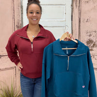 This half zip pullover features a crop fit, front kangaroo pocket, raglan sleeves, ribbed cuffs &amp; hem, large fold over collar with simply southern logo label. made of 48 modal, 48 polyester and 4 spandex.&nbsp;