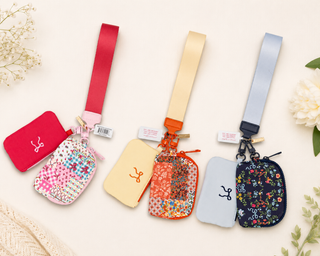 The little bag that does a lot. This Simply Southern ID Coin Wristlet keeps your essentials organized and close at hand — perfect for running errands, heading to a game, or anytime you want to travel light without sacrificing style.

Key Details | Two compact pouches: one solid, one patterned
Strap | Matching wrist strap included
Function | ID window and coin pouch in one convenient wristlet
Style | Available in Pink Quilted Ribbon, Orange Quilted Floral, and Navy Ribbon Floral
Brand | Simply Southern