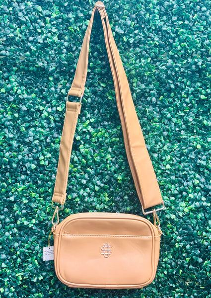 The Simply Southern Ibiza Crossbody blends style and function with PU leather, zip top closure, front pocket, and fully lined interior with card sleeves and zip pocket. Features detachable strap and Simply Southern logo.