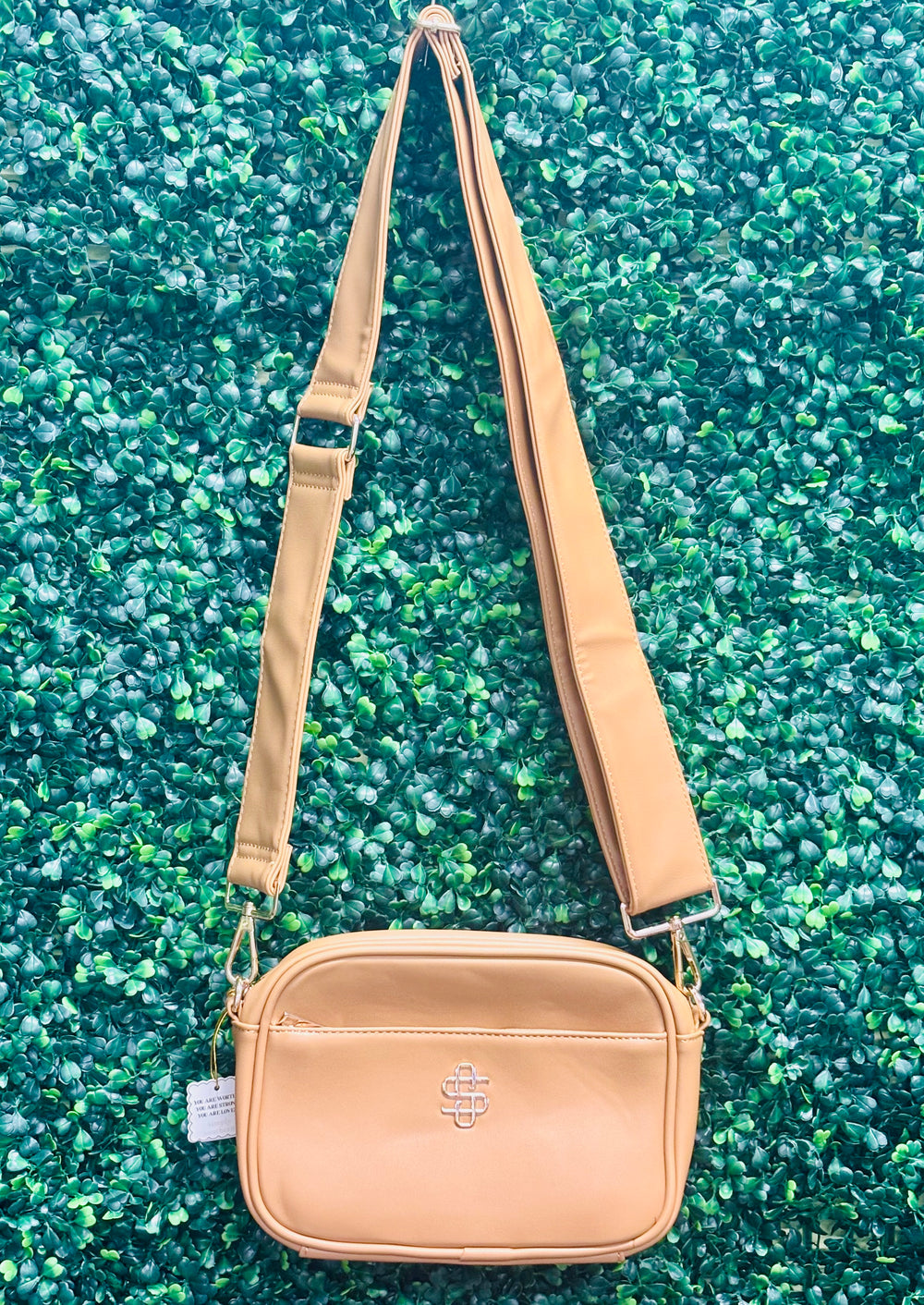 The Simply Southern Ibiza Crossbody blends style and function with PU leather, zip top closure, front pocket, and fully lined interior with card sleeves and zip pocket. Features detachable strap and Simply Southern logo.