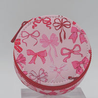 Pink round pouch with bow pattern on a white background