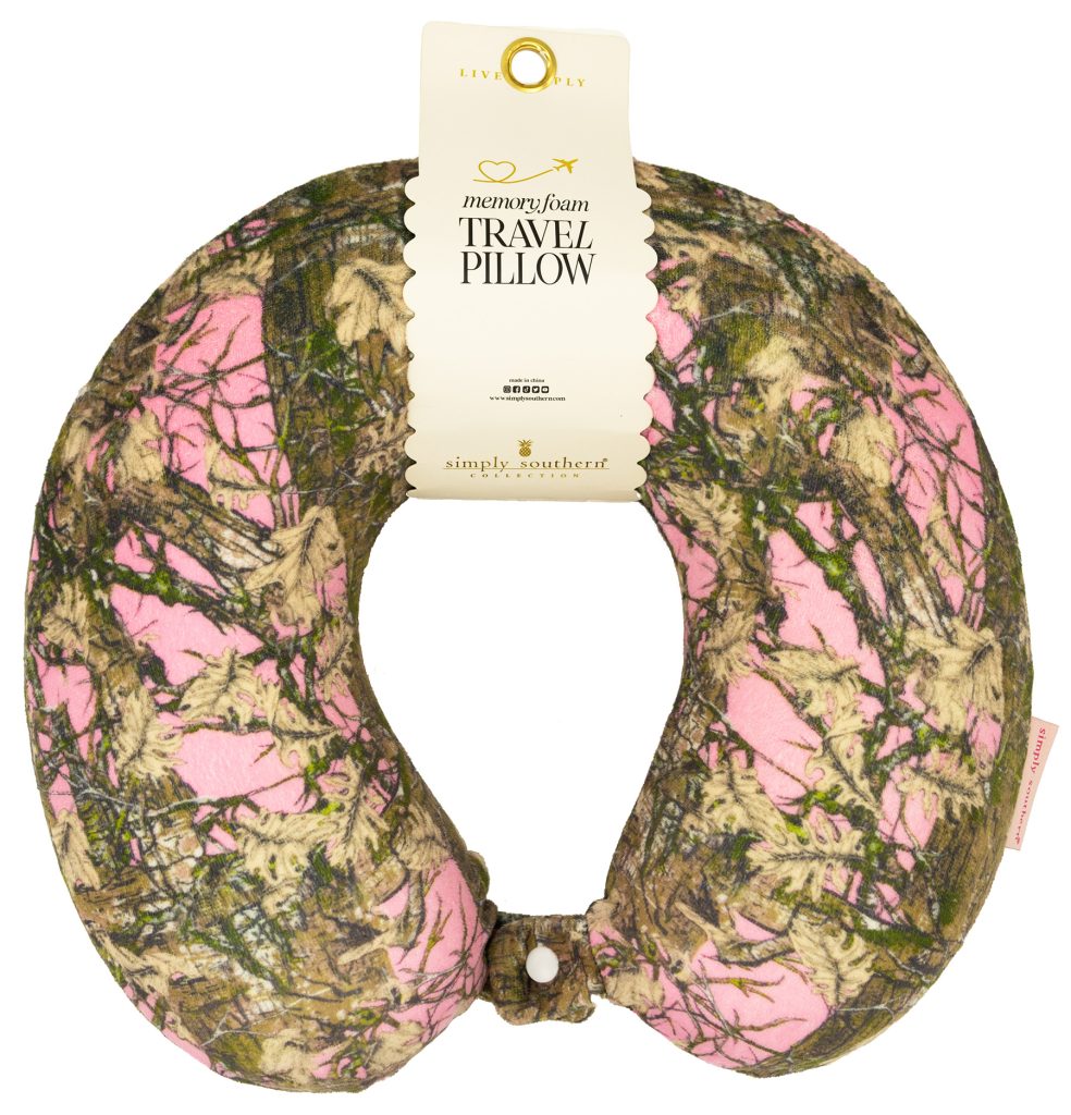 Travel pillow with pink and green camouflage pattern on a white background