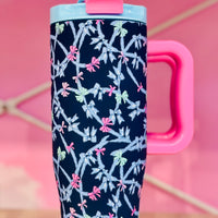 Navy blue tumbler with pink handle and bow pattern