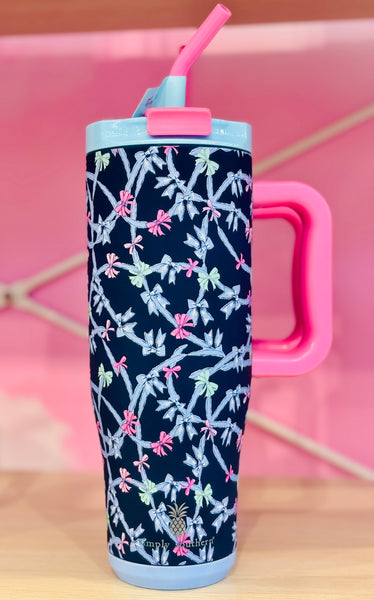 Navy blue tumbler with pink handle and bow pattern