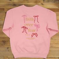 Pink sweatshirt with 'faith over fear' text and ribbons on a white background