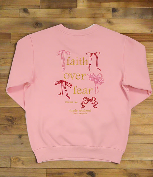 Pink sweatshirt with 'faith over fear' text and ribbons on a white background