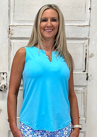 The Sleeveless Keyhole Top in Turquoise features a V-style neckline with a delicate keyhole detail — that bright, clear turquoise hue brings an instant coastal energy to any outfit, whether you're pairing it with white denim for a casual day out or tucking it into a linen skirt for something more polished.