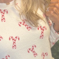 Festive Candy Cane Print – Perfect for Christmas mornings
 Relaxed Fit Crew Neck Top – Soft and breathable
Straight Leg Pants with Elastic Waistband & Drawstring – Adjustable comfort
Elastic Cuffs at Ankle – Stay-in-place fit for cozy wear
Inseam: 27"
Fabric: 96% Polyester / 4% Spandex – Stretchy 