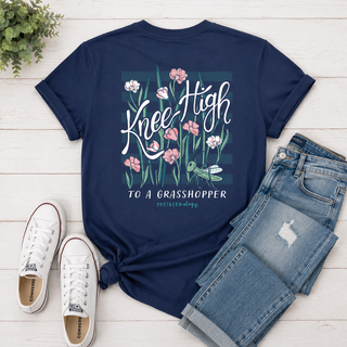 Our Southernology® Knee High to a Grasshopper Tee features a playful floral and grasshopper graphic on a classic navy comfort color short sleeve shirt. Bright, fun, and full of Southern charm, it’s an easy everyday tee with a cute vintage feel.
