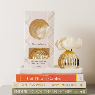 Sweet Grace mercury flower diffuser with gold and silver vase and decorative flower.