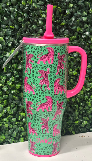 Big capacity, bold print. The Swig Mega Mug in Easy Tiger brings fierce, fun energy to your daily hydration routine. At a full 40oz, it keeps cold drinks icy for 24+ hours and hot drinks warm for 9+ — from your morning iced coffee to your afternoon on the go. Green background with hot pink tiger designs