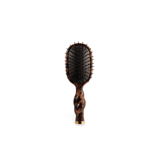 The Mini Vented Hair Brush in tortoise is designed for fast, easy styling on-the-go. Its vented design supports airflow and even heat distribution.