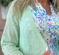 The Lulu-B Textured Cardigan in Lime features a beautiful woven pattern with a richly textured fabric that adds a bold pop of color and subtle dimension to any outfit — super lightweight construction provides breezy arm coverage without adding warmth, making it the perfect layer for warm-weather days when you want to stand out without overheating.
