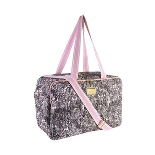 Pattern | Zebra with signature pink accents
Material | Quilted cotton exterior with soft cotton lining
Dimensions | 18" W x 8.5" D x 12" H (45.7 cm x 21.6 cm x 30.5 cm)
Handles | Two sturdy top carry handles
Strap | Adjustable, removable shoulder strap — extends up to 57" (144.8 cm)
Pockets | 2 interior zipper pockets + front zipper pocket (6" x 7")
Structure | Removable base insert for added support
Travel Feature | Built-in trolley sleeve slides over rolling luggage handles