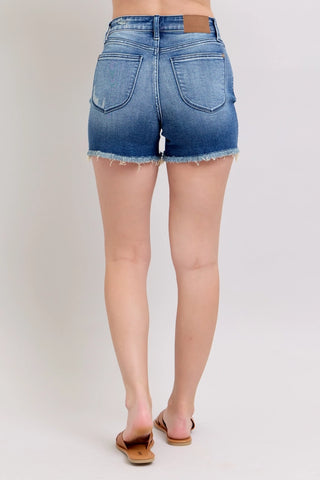 Trendy, flattering, and made for your best warm-weather days. The Judy Blue V-Front Shorts with Shield Pockets bring a fresh, fashion-forward twist to classic denim — a unique V-front design, shield pockets, and a high waistline create a contemporary, refined silhouette that works effortlessly from casual everyday wear to spring and summer outings. Crafted from a 93% Cotton / 5% Polyester / 2% Spandex blend, they offer a comfortable fit and easy movement all day long.