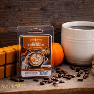 Vanilla Pumpkin Latte wax melt package with coffee beans and a cup of coffee on a wooden surface.