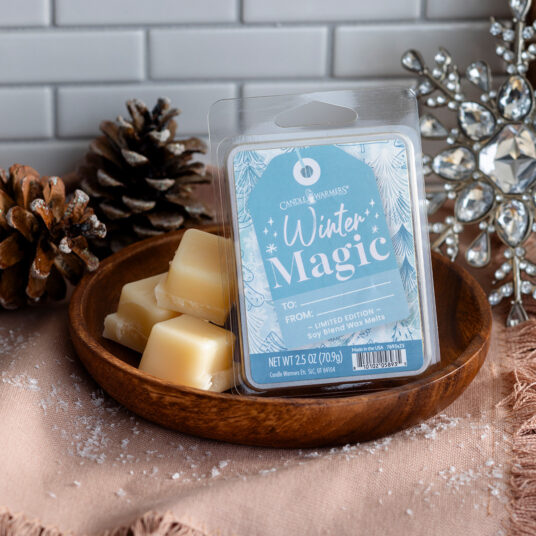 Candle Warmers Wax Melt package labeled 'Winter Magic' on a wooden tray with decorative elements.