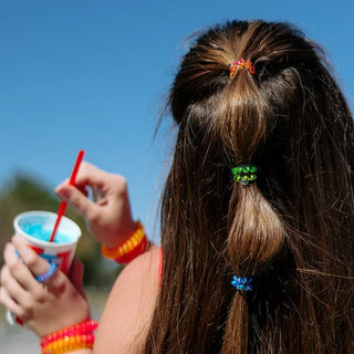 These mini hair coils are designed to fit an adult finger like a ring rather than a bracelet, offering a&nbsp;strong, damage-free grip&nbsp;that keeps hair in place all day—without breakage, creases, or headaches.

Strong grip, no rip design for all-day hold

Great for little kids or super thin hair
Durable and waterproof for all occasions
Gentle on hair—prevents breakage, headaches and creases

Sold in packs of five.
