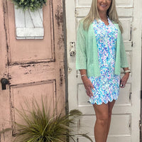 Stay stylish and sun-safe in this sleeveless dress with a scalloped neckline. Made with UPF50 cooling fabric, it offers comfort, protection & effortless charm.