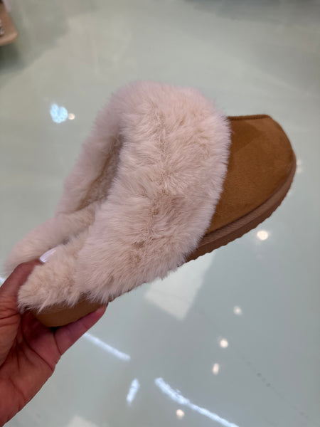 Brown slipper with fluffy white lining.