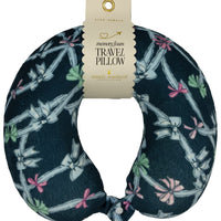 Travel pillow with bow pattern and packaging on a white background
