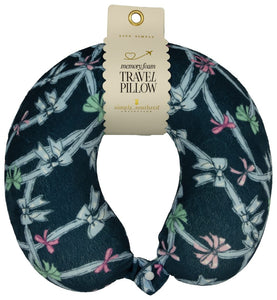 Travel pillow with bow pattern and packaging on a white background