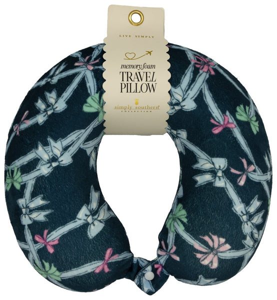 Travel pillow with bow pattern and packaging on a white background