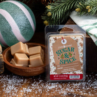 Candle Warmers Sugar & Spice wax melt package with Christmas decorations in the background